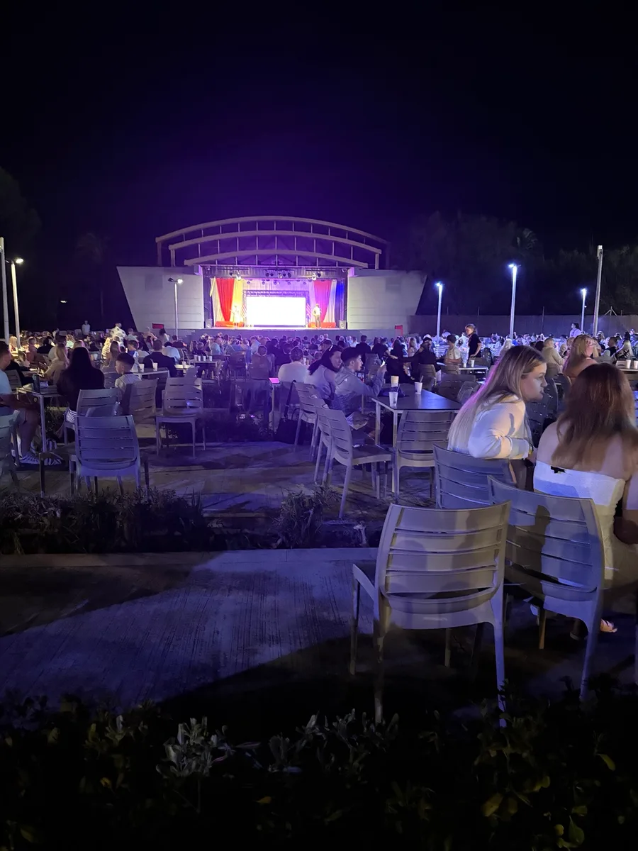 Outdoor entertainment stage and seating area at night